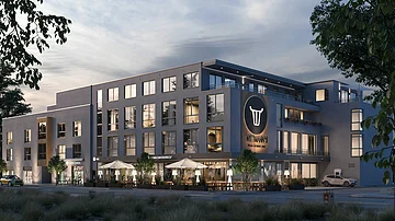 Modernes Gebäude mit mehreren Stockwerken, großen Fenstern und einem Restaurant im Erdgeschoss. Bäume im Vordergrund.